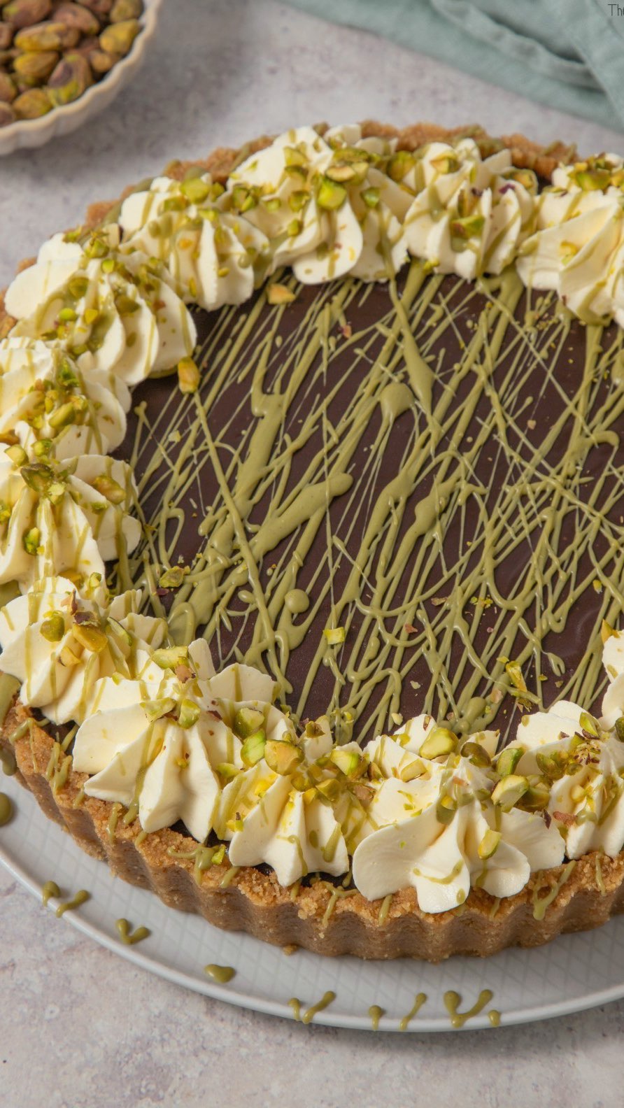 Instagram post by @thebakingexplorer for Black Milk. Caption reads: New! Dubai Chocolate & Pistachio Tart - a....