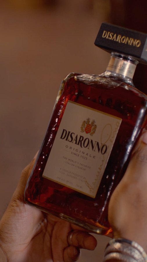 Instagram post by @xxjmitch for Disaronno. Caption reads: Being around friends with a bottle of....