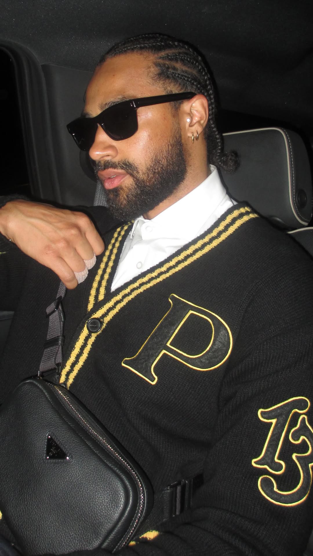 Instagram post by @deaven.booker for EssilorLuxottica. Caption reads: To close out the look🕶️ @prada @essilorluxottica ....