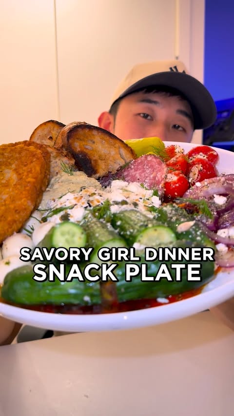 Instagram post by @checkoutvick for Trader Joe's. Caption reads: Rating the viral Savory Girl Dinner Snack Plate....