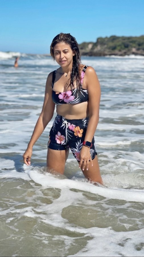 Instagram post by @simrangulatiofficial for Okanui. Caption reads: [...] THE SOUL LIKE A DAY
BY THE WATER🌺☀️👙....