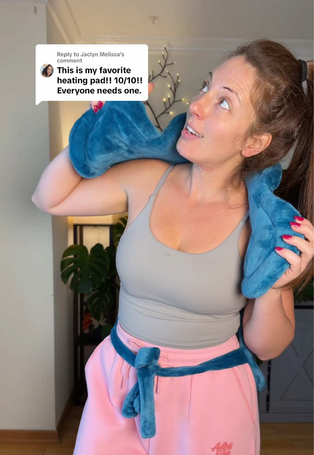 TikTok post by @jackieriso for RENPHO. Caption reads: [...] shoulder heating pad around! Use code....