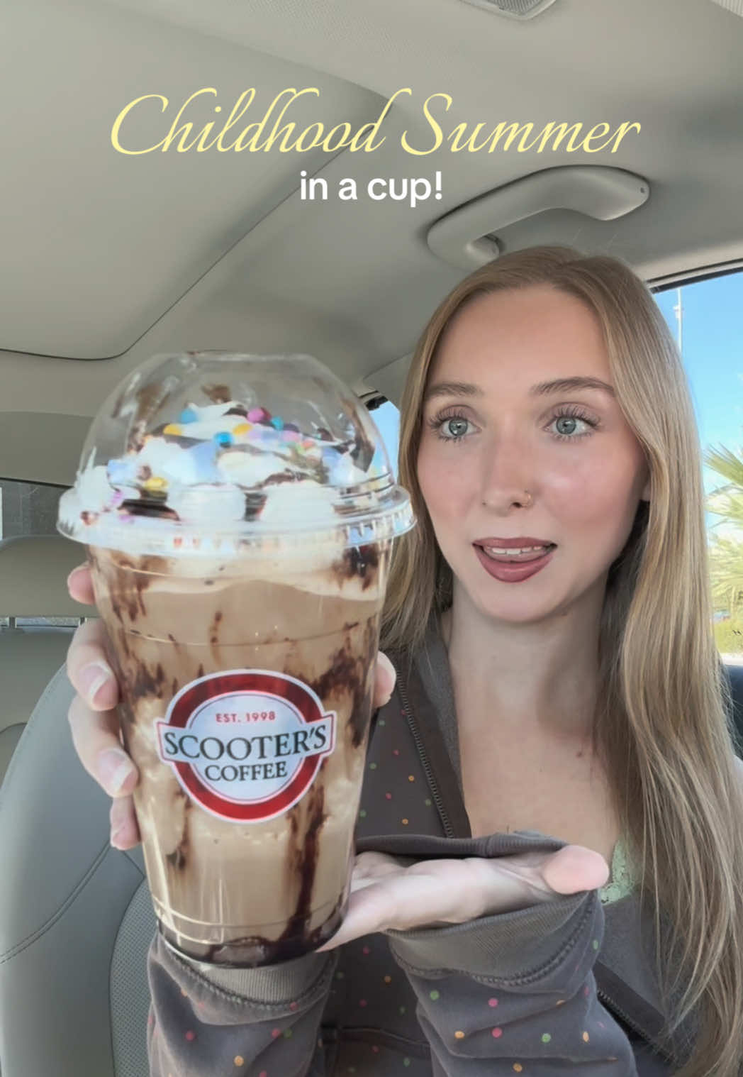 TikTok post by @emmalizzz for Scooter's Coffee. Caption reads: [...] off 1 medium Cosmic Brownies drink!....