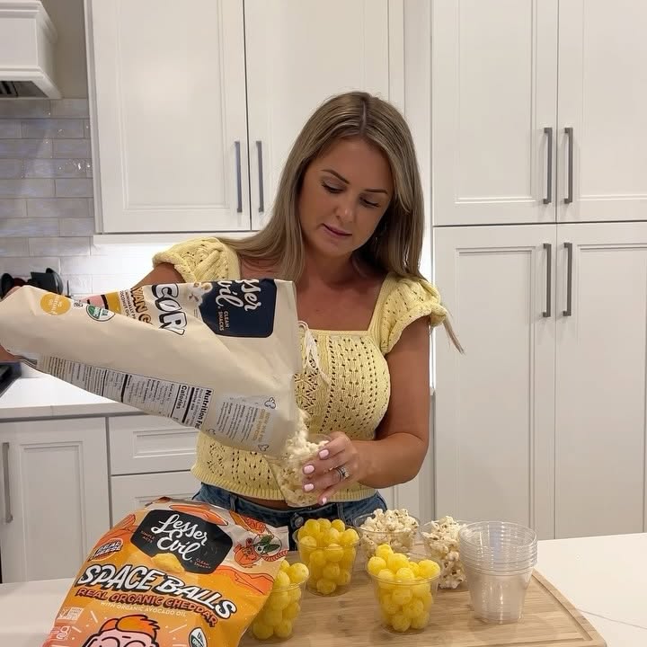 Instagram post by @camenyoungblood for LesserEvil Kids. Caption reads: LesserEvil snacks are the star of the show in....