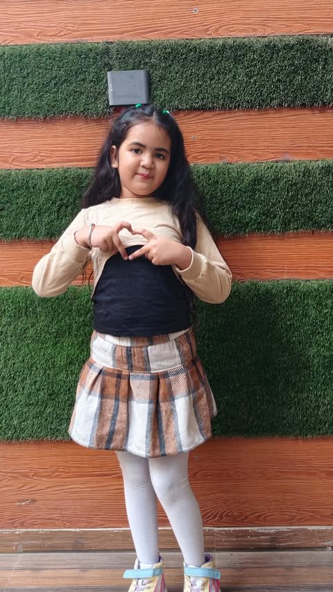 Instagram post by @geetika.aishvi.official for Hopscotch. Caption reads: [...] cuteness in plaid, curls & bows 🥒💚✨....