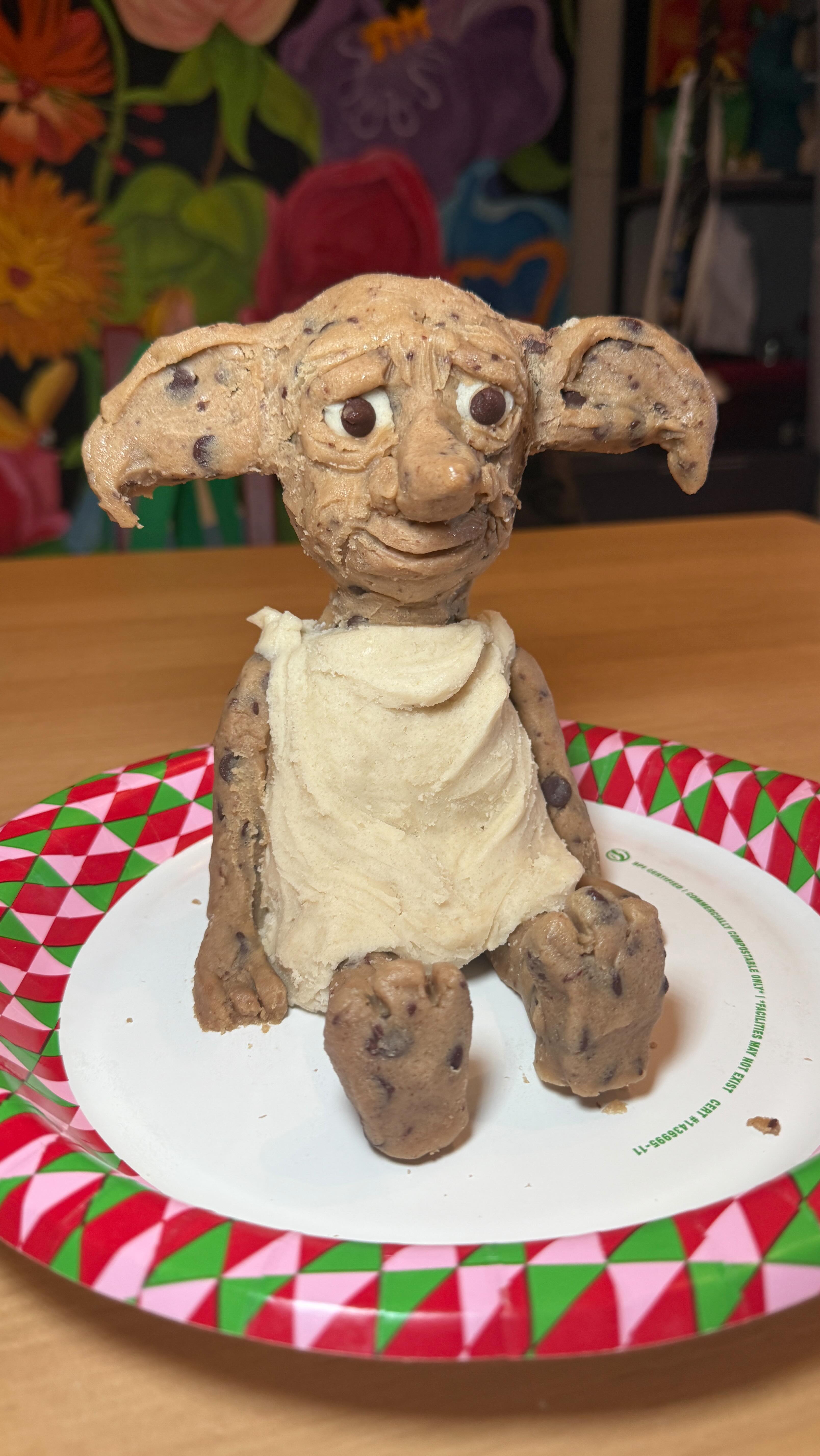 Instagram post by @katiebettini for Harry Potter. Caption reads: #ad Master made Dobby a Cookie! 🧦 🧙🏼‍♀️ ✨ 🍪....