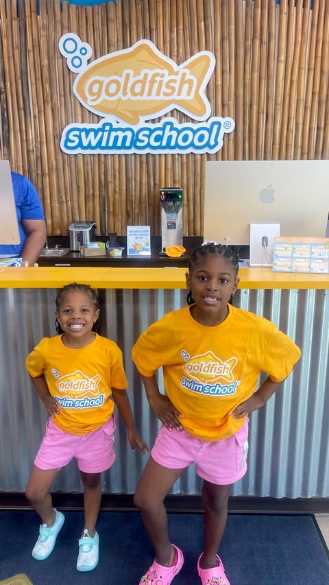 Instagram post by @bossmomlivin for Goldfish Swim School. Caption reads: [...] girls are officially enrolled at Goldfish....