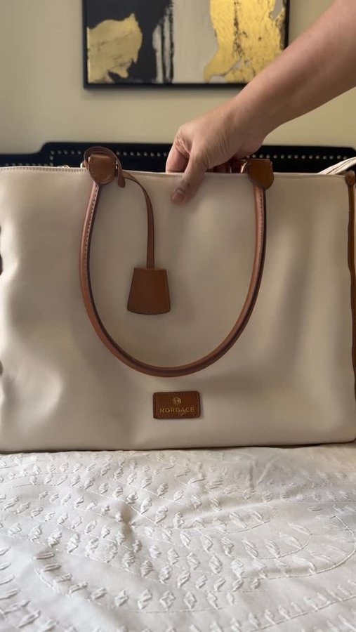 Instagram post by @herwinsomecharm for Nordace. Caption reads: Meet my new travel bestie ✈️ The Nordace Rivera....