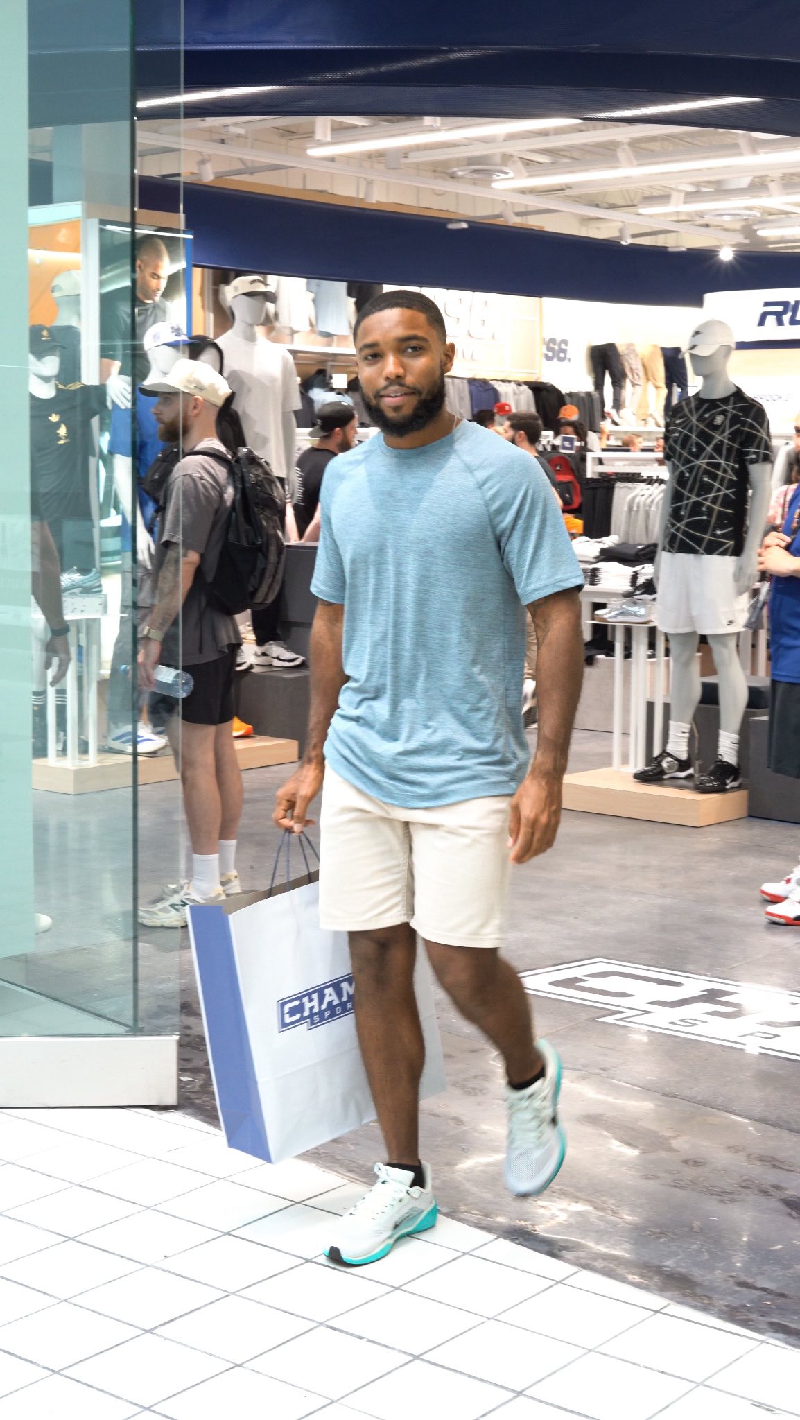 Instagram post by @iamspreadtheword for Champs Sports. Caption reads: #ad Champs Sports Brandon Grand Opening was an....