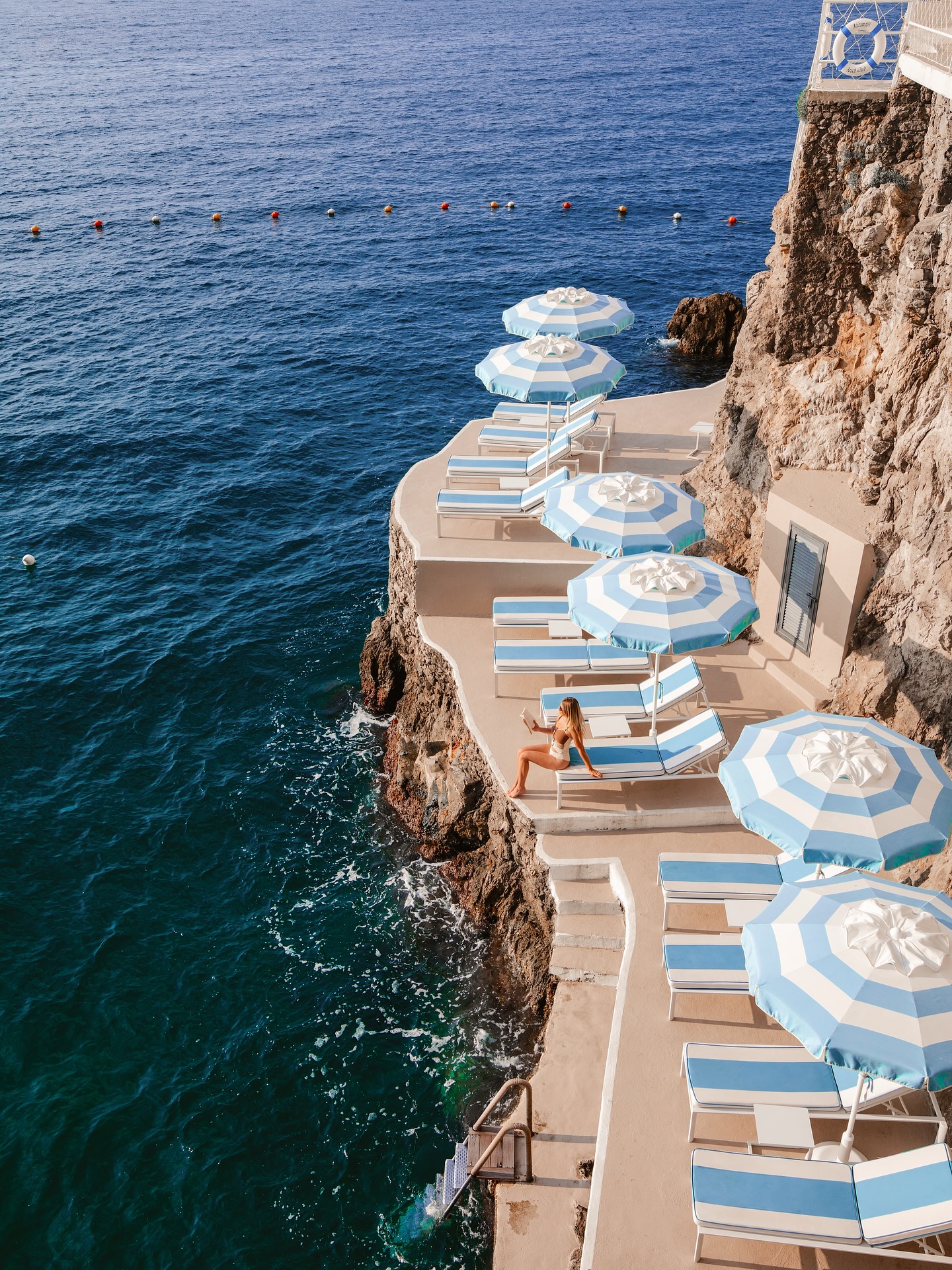 Instagram post by @the_essentialist_ for Tripadvisor. Caption reads: A morning at @hotelmiramalfi Beach Club⛱️. This....