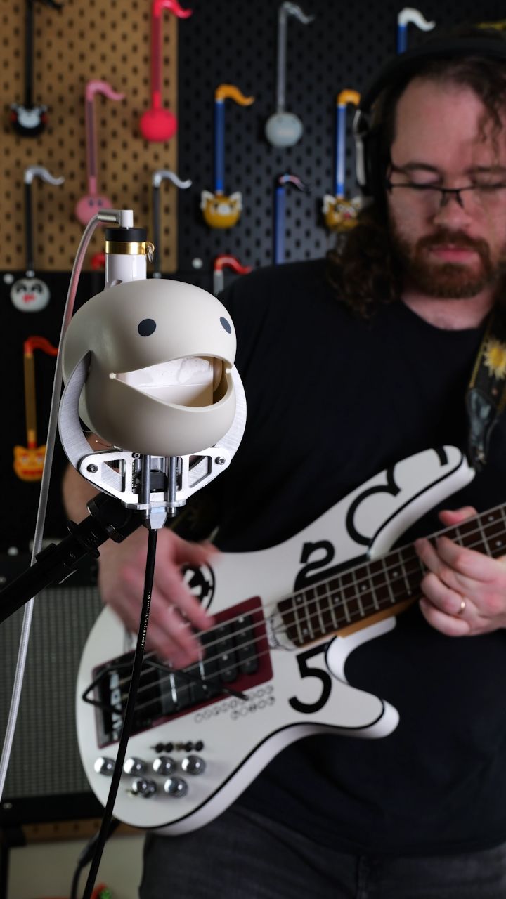 Instagram post by @moshibass for PCBWay. Caption reads: I turned an Otamatone head into a guitar....