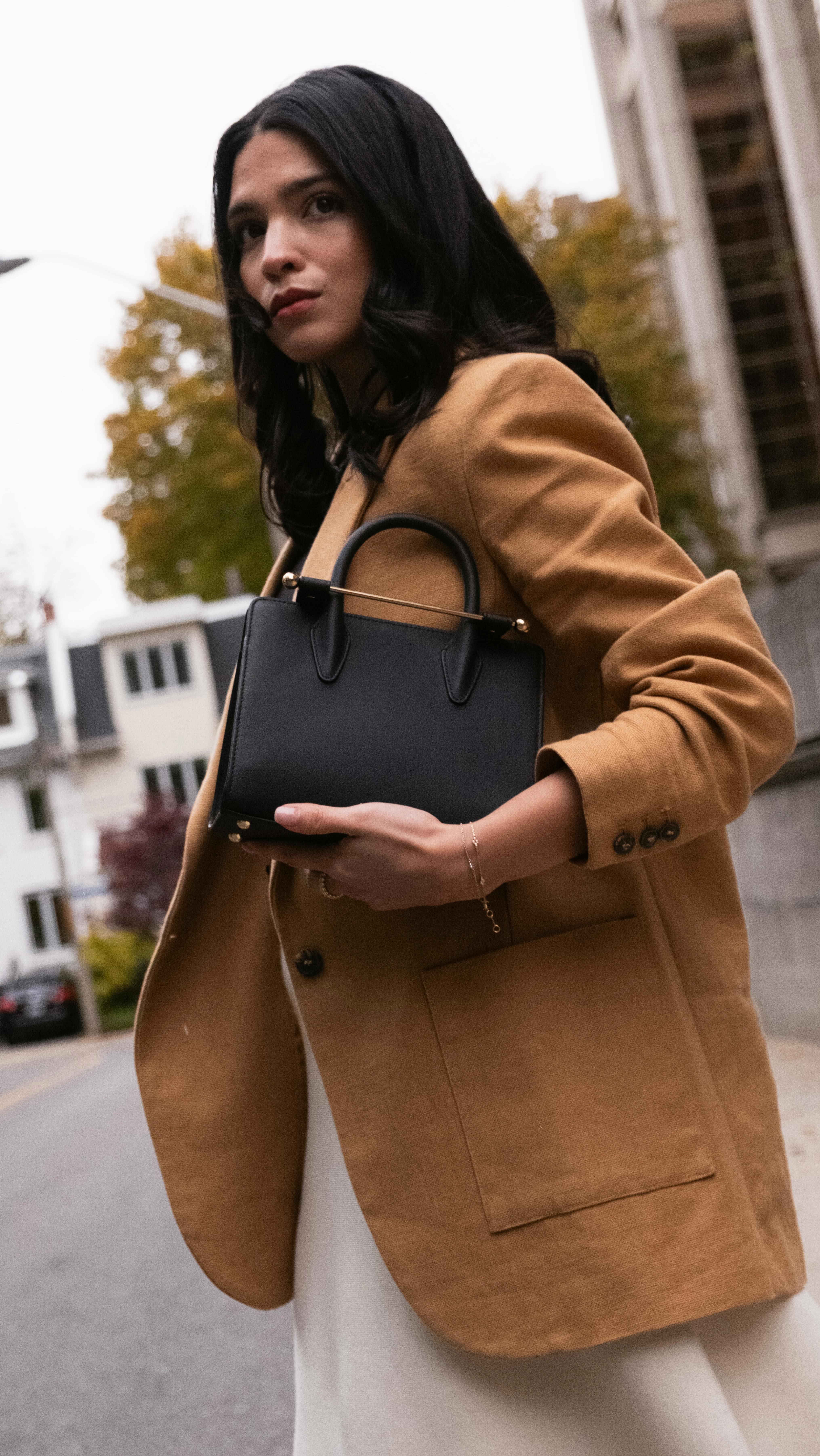 Instagram post by @samanthaguerrero_ for Strathberry. Caption reads: Ad. Which bag should I keep? Mini Tote or Mosaic....