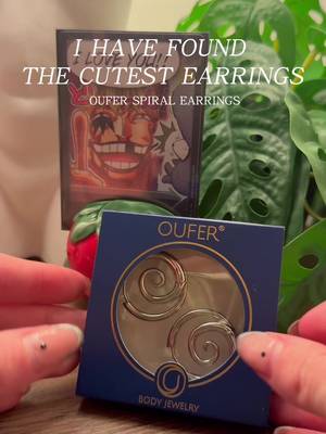 TikTok post by @justchloe.xo for Oufer Body Jewelry Official. Caption reads: CALLING ALL CORALINE FANS! these earrings might....