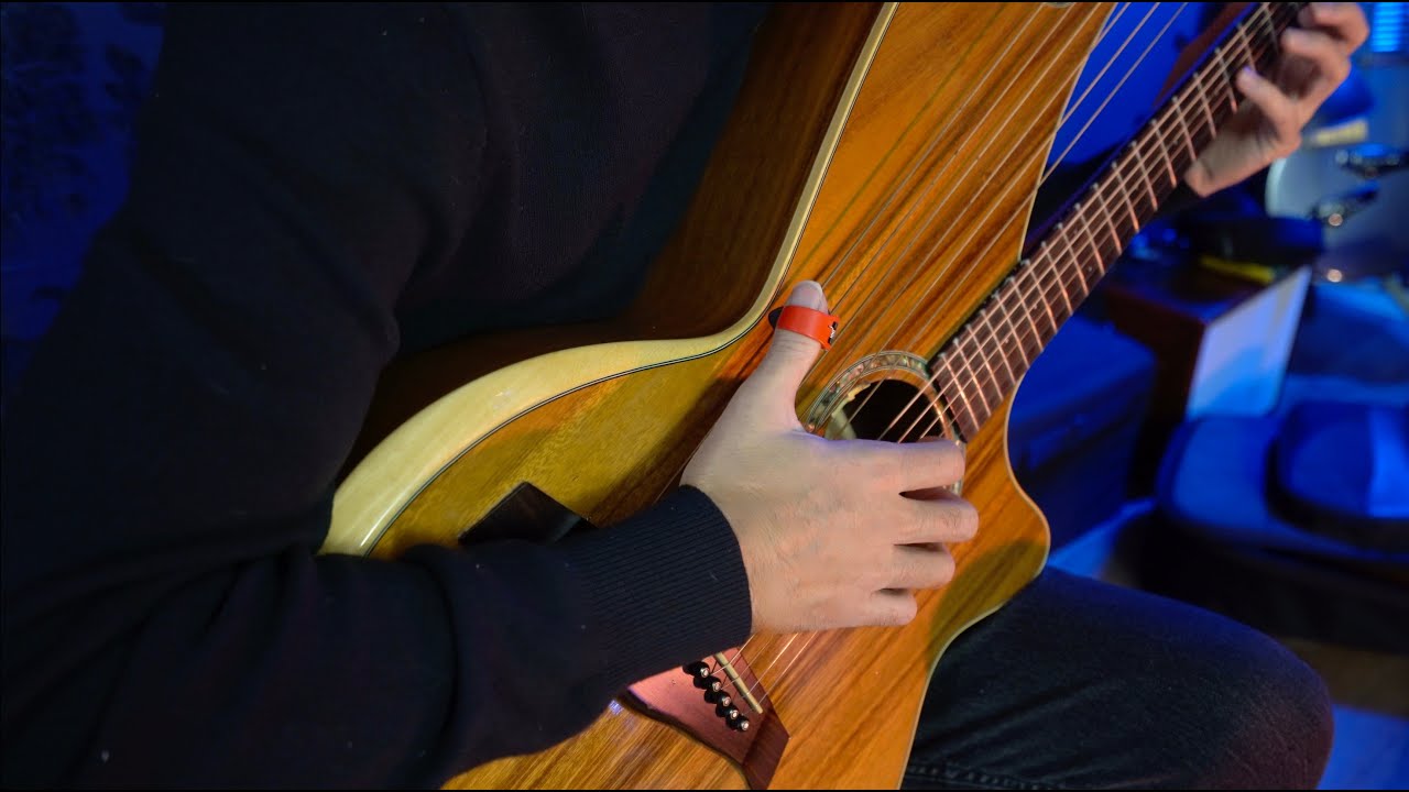 YouTube post by @JamieDupuisMusician for LANDR. Caption reads: Hark The Herald Angels Sing - Harp Guitar (Calming....