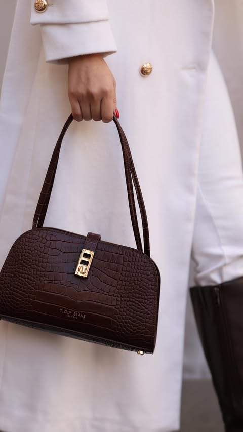 Instagram post by @ninnanatsvlishvili for Teddy Blake. Caption reads: I am obsessed with my new @teddy_blake bag!....