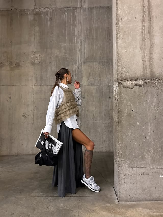 Instagram post by @_olhirst_ for Schuh. Caption reads: Channelling spring 🖤 In my @nike P-6000 @schuh AD.