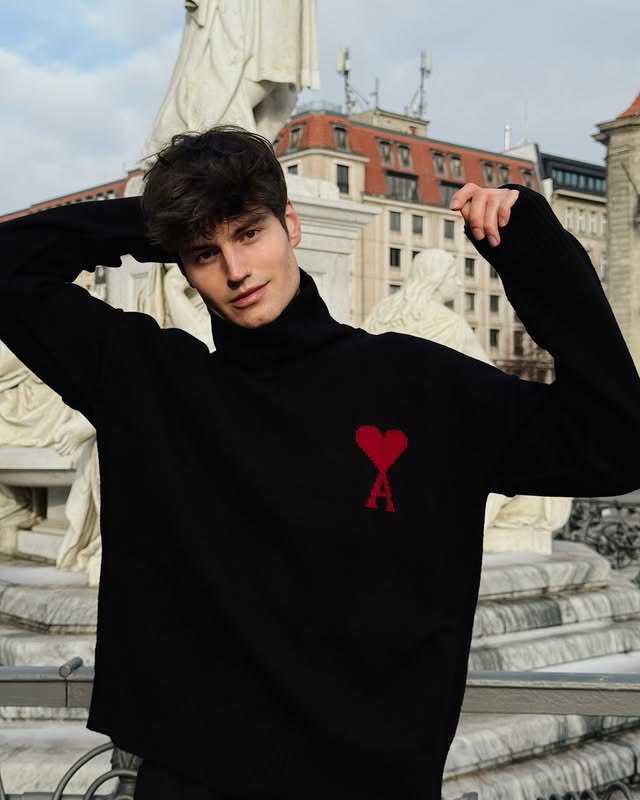 Instagram post by @moritz_hau for AMI Paris. Caption reads: Sweater Weather @amiparis ad.