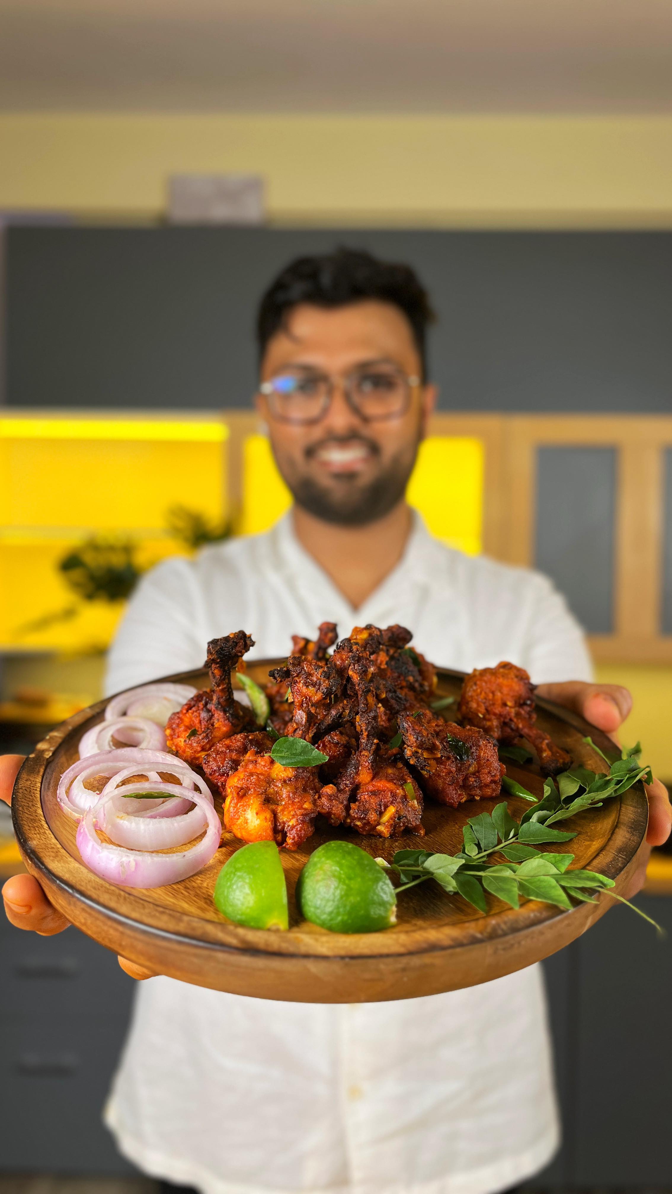 Instagram post by @the_bong_gastronomist for freshtohome. Caption reads: Crispy Chicken 65 Lollipops – because who said....