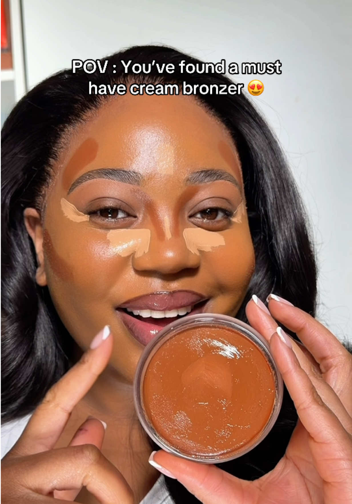 TikTok post by @makeupbymissevelyn for HNB Cosmetics. Caption reads: this @HNB Cosmetics glossy skin bronze tint in....