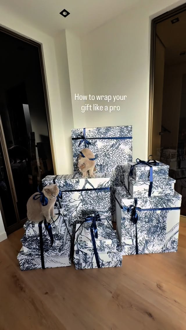 Instagram post by @dmdliving for Photowall. Caption reads: AD| How to wrap your gift like a pro this....