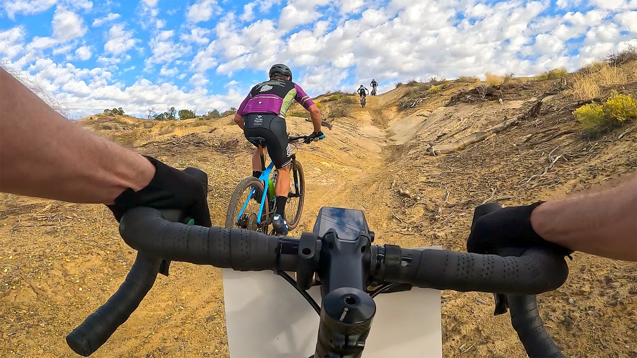 YouTube post by @sydandmacky for Skratch Labs. Caption reads: I took a gravel bike to a mountain bike race (Road....