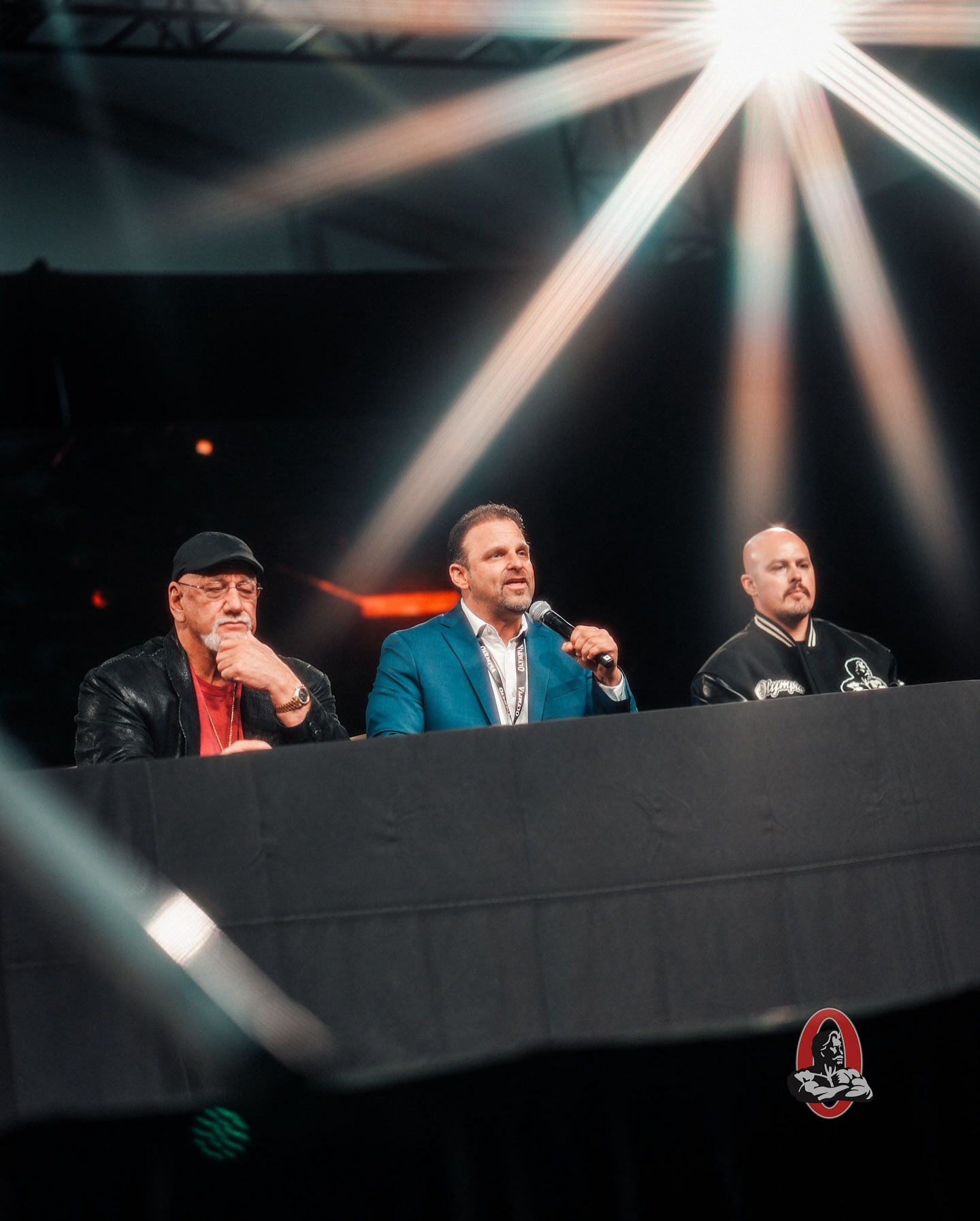 Instagram post by @jake_wood_media for FLEX Magazine. Caption reads: 2025 @mrolympiallc Athletes Meeting 
Olympia PPV:....