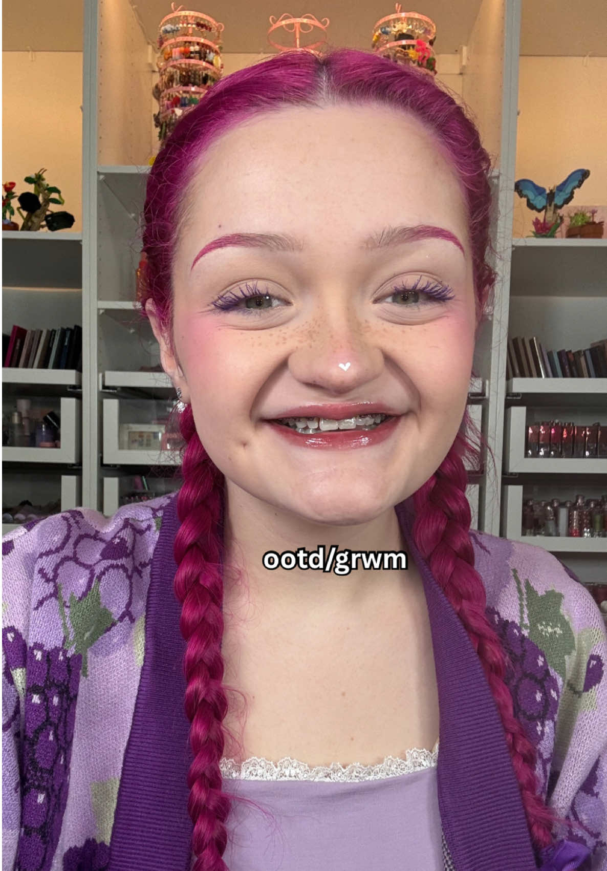 TikTok post by @linsmakeuplooks for Glossier. Caption reads: they did surgery on a grape products used: OUTFIT....