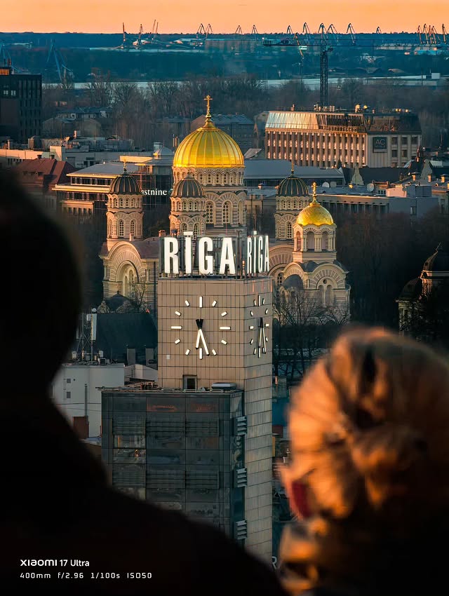 Instagram post by @egonslacis for Xiaomi Latvia. Caption reads: 🌇 Vakara mirklis virs Rīgas.. | foto uzņemts ar....