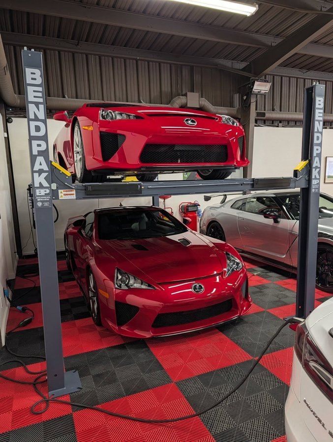 Instagram post by @larry_chen_foto for BendPak. Caption reads: It's a flex to have one LFA in red, it's an....