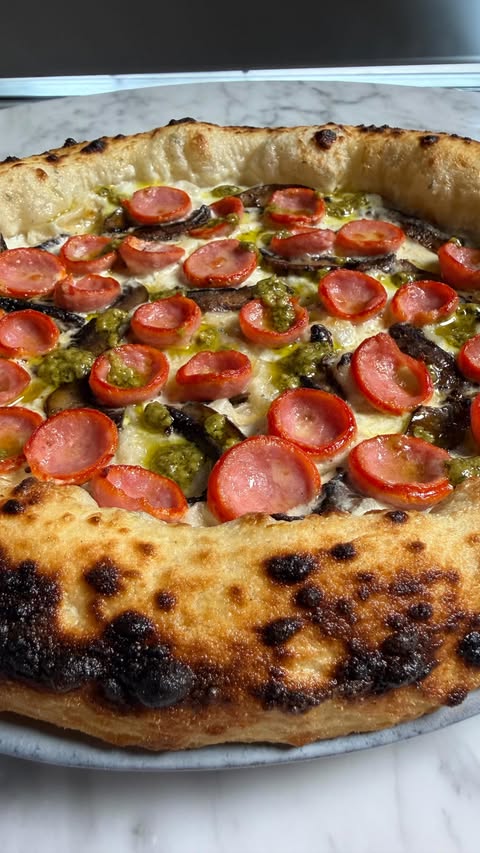 Instagram post by @7thfloorpizza for Ooni. Caption reads: Sausage cups like this always make me smile. The....