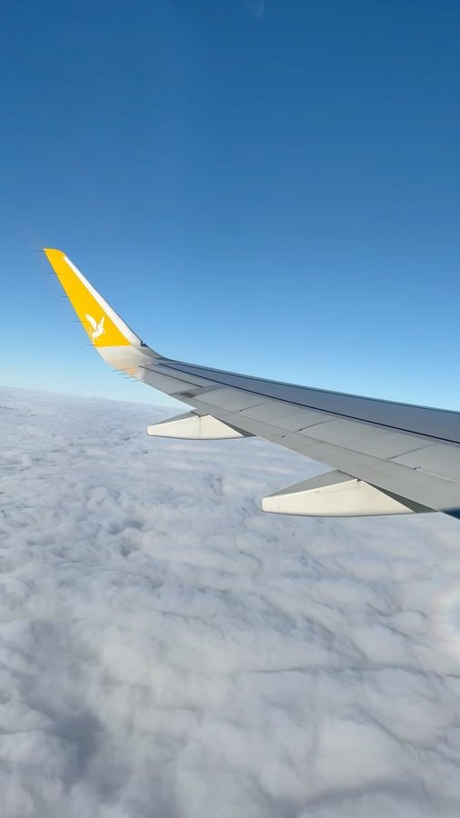 Instagram post by @caglaakcasaygi for National Geographic Travel. Caption reads: Above the clouds ☁️☁️☁️✈️ #pegasusairlines....