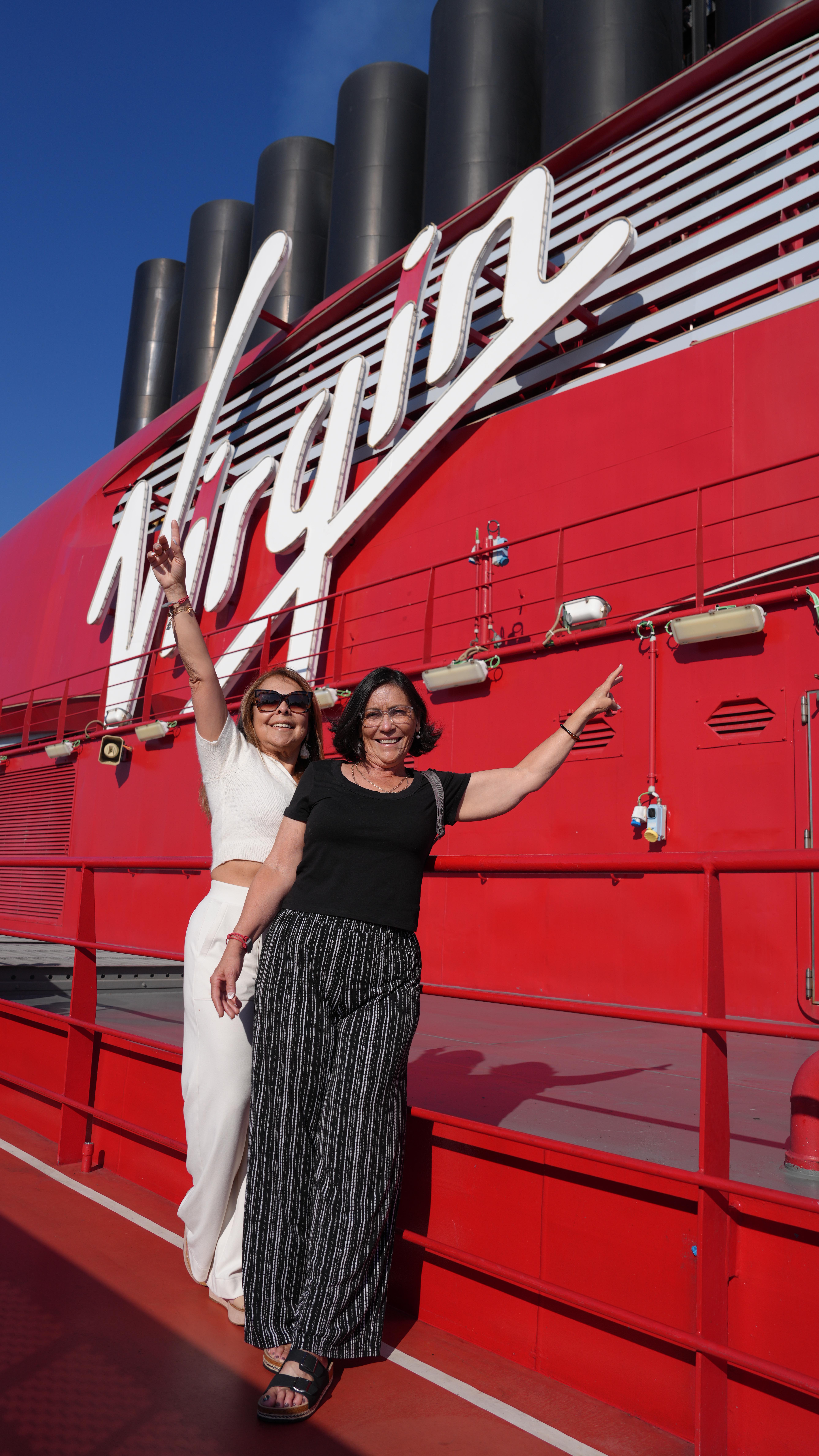 Instagram post by @reallouisandre for Virgin Voyages. Caption reads: Me and @greyinspire surprised our moms with the....