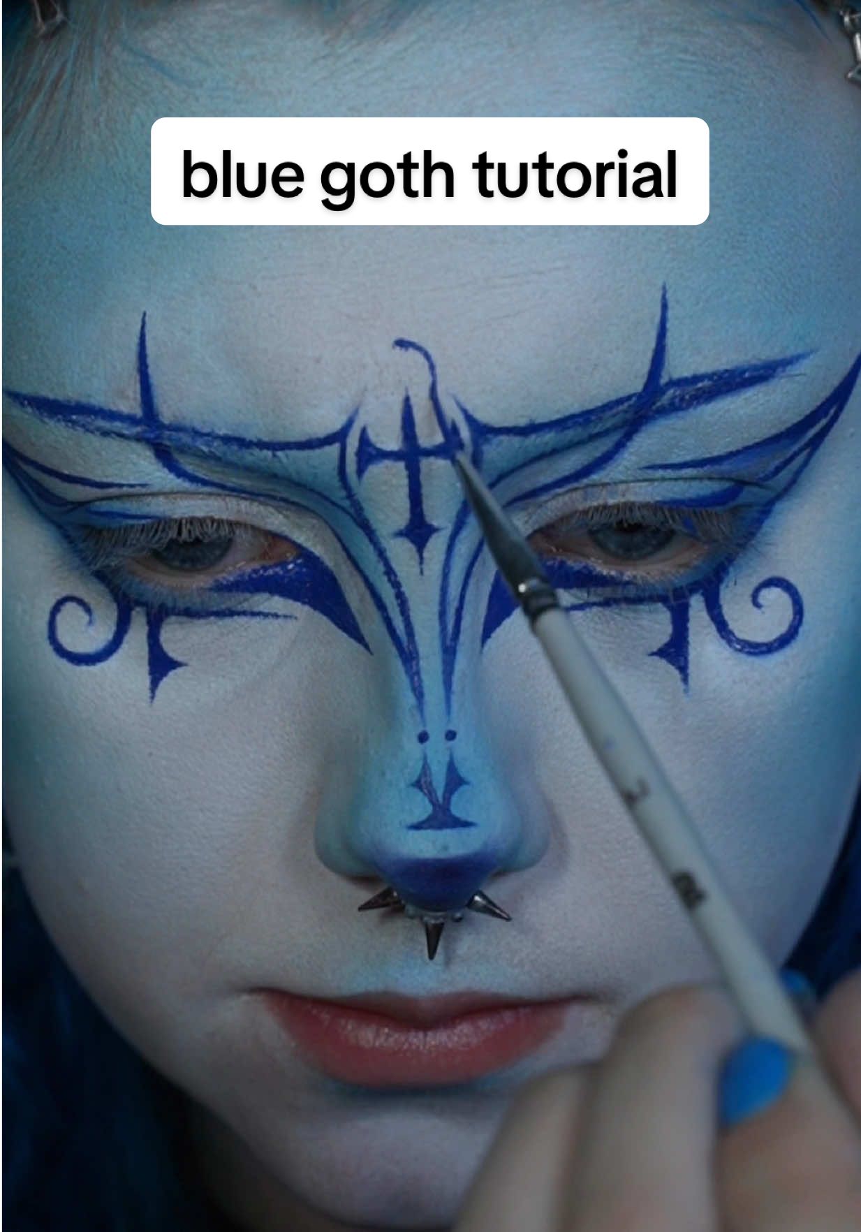 TikTok post by @pippabarnes for RCMA Makeup. Caption reads: blue goth makeup ib: @Julie🕷️ this may have taken....