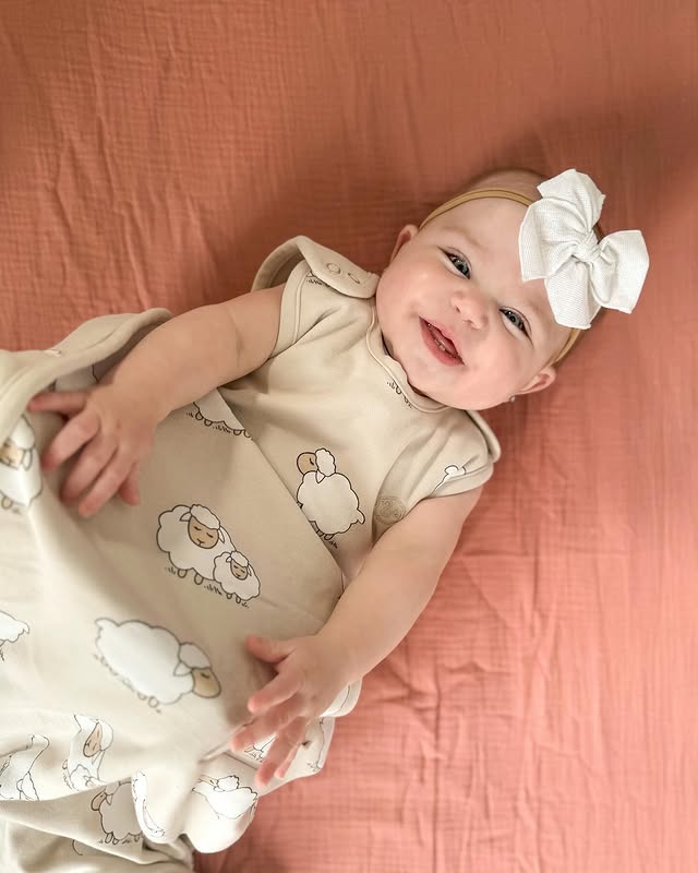 Instagram post by @rachelle.katlyn for Woolino. Caption reads: [...] happiest baby in the softest sleepsack!....