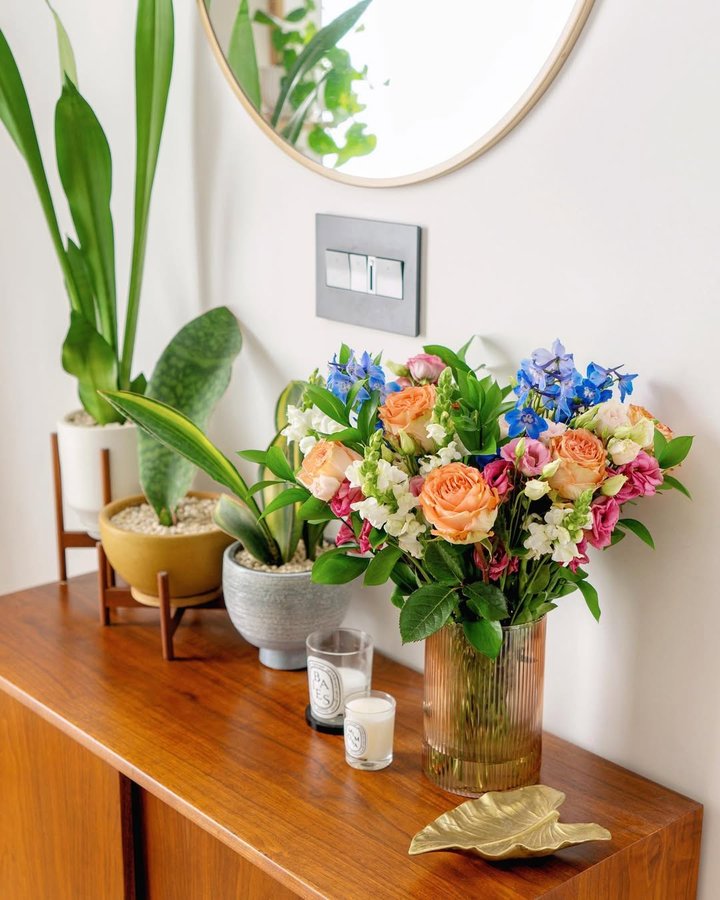 Instagram post by @cubehousejungle for UrbanStems. Caption reads: [...] around the house! (Flowers are from....