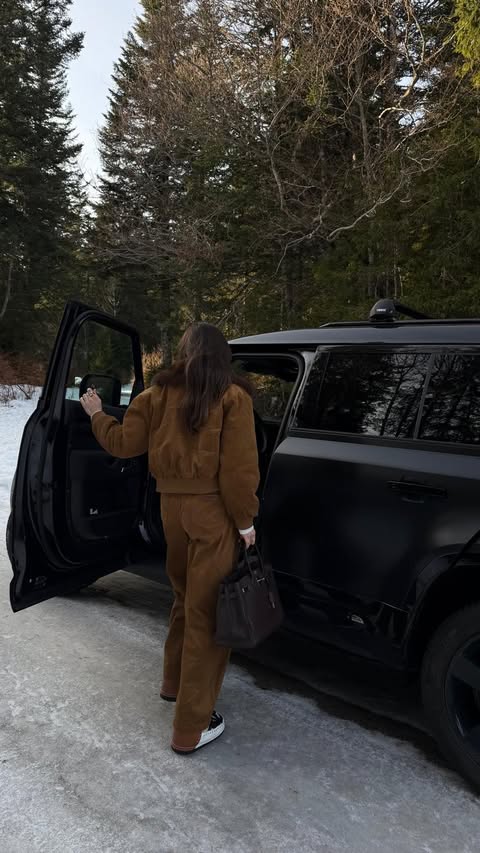 Instagram post by @gigischmitz_ for The Couture Club. Caption reads: What I wear to disappear into the mountains 

ad.