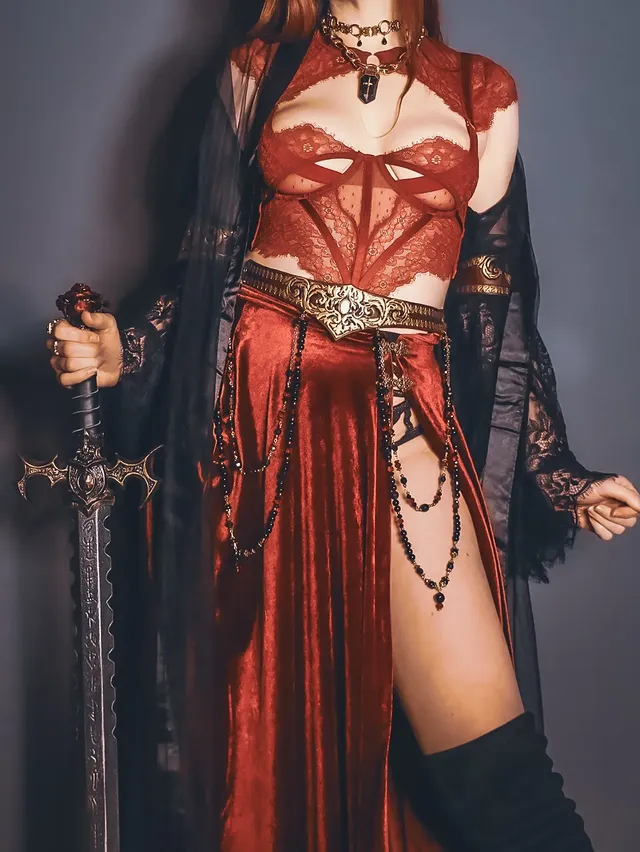 Instagram post by @thescarletthuntress for REGALROSE.com. Caption reads: I heard the call of a dragon 🐉 Team Red & Black....