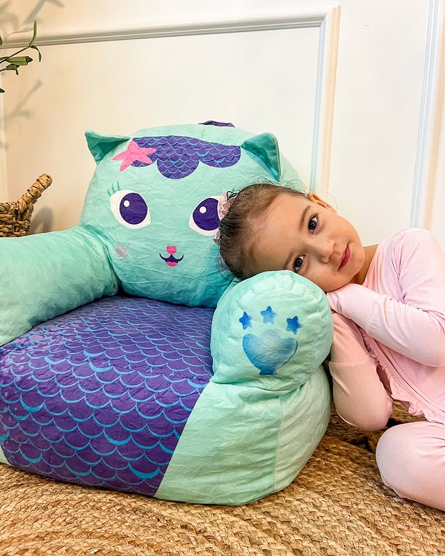 Instagram post by @paloma_eliane for Delta Children. Caption reads: Snuggling up in @deltachildren Gabby’s dollhouse....