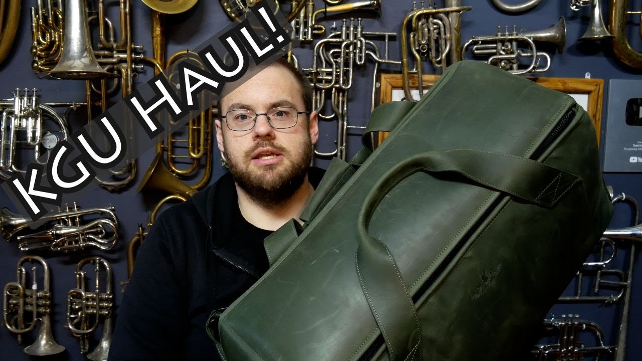YouTube post by @TrentHamilton for Kgumusic. Caption reads: MG Leather and KGU Accessories Haul!.