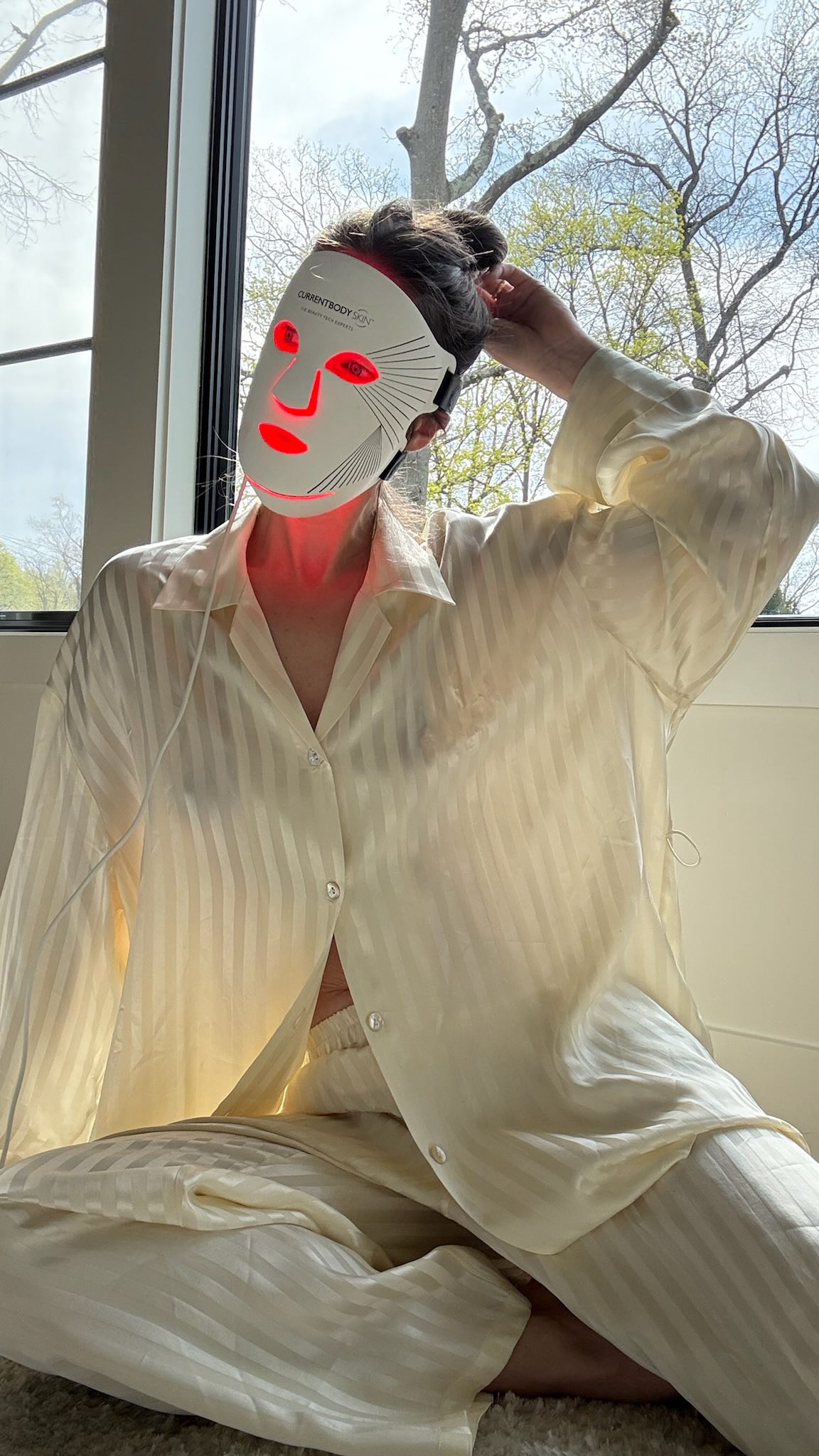 Instagram post by @emilydidonato for currentbody. Caption reads: Red light therapy for your face AND neck? Yes....