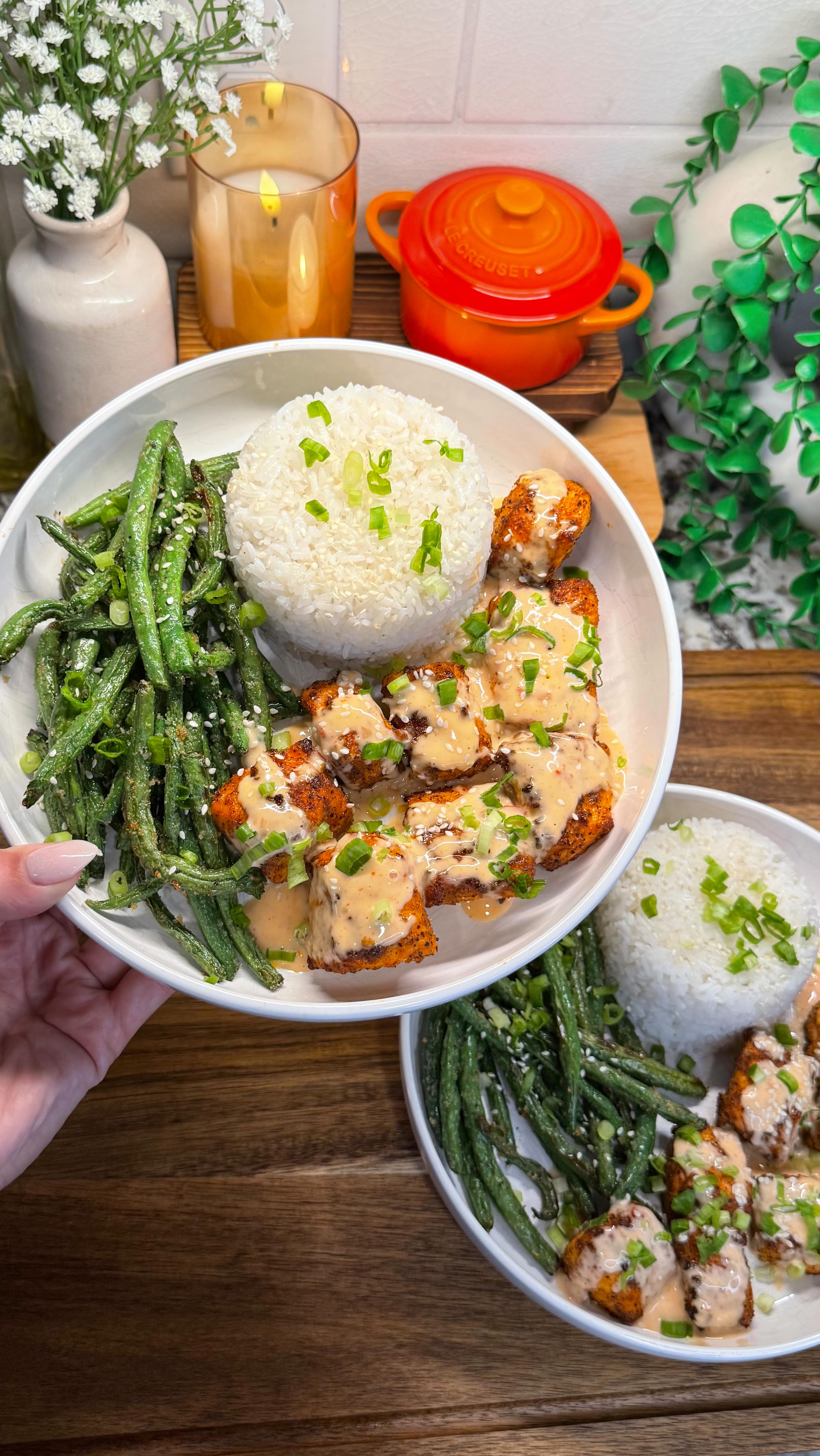 Instagram post by @cookwithauds for PowerXL. Caption reads: air fryer bang bang salmon bowls are our weeknight....