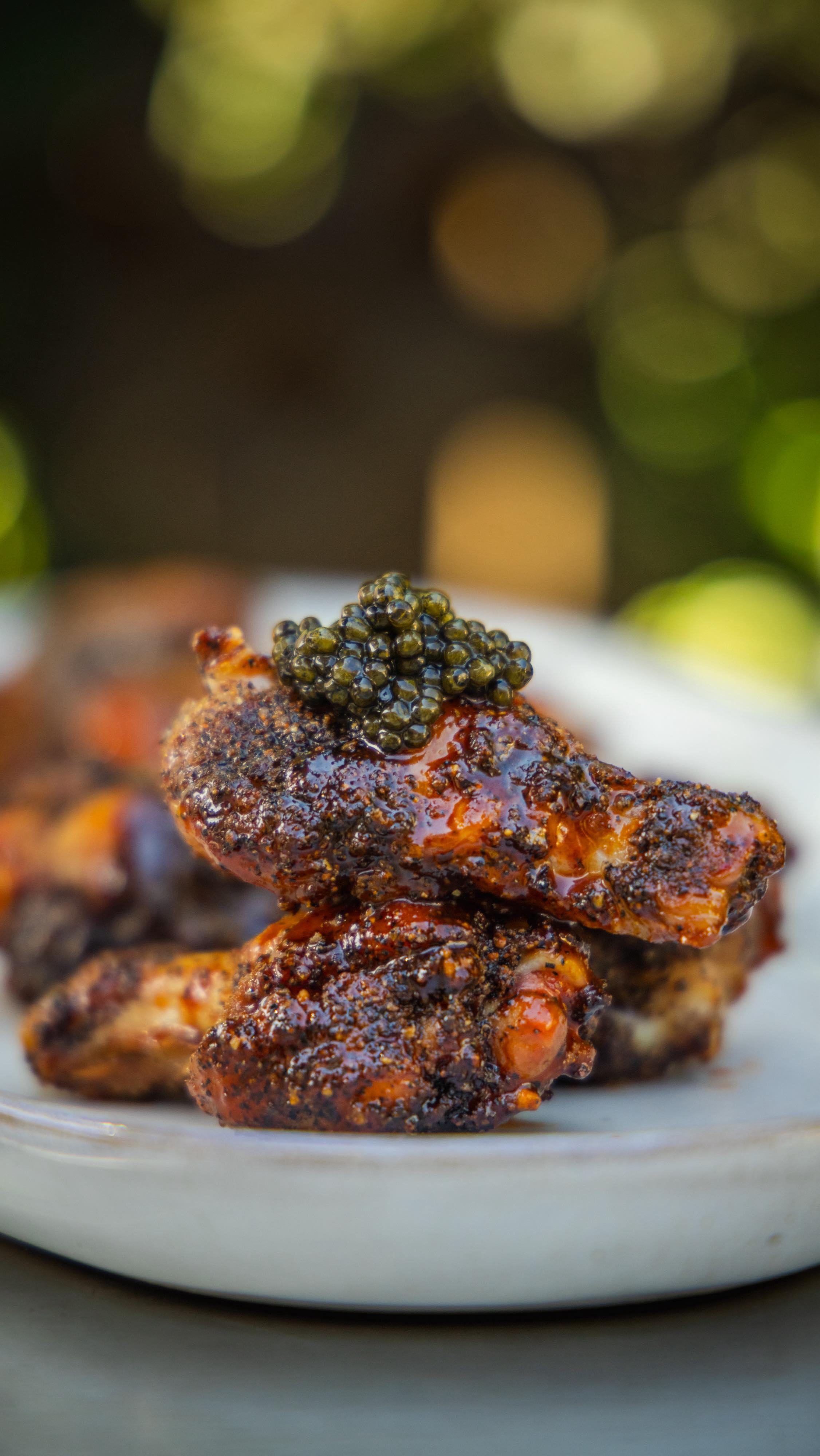 Instagram post by @briewilly for Traeger Grills. Caption reads: SMOKED & TALLOW FRIED CAVIAR WINGS
.
It's....