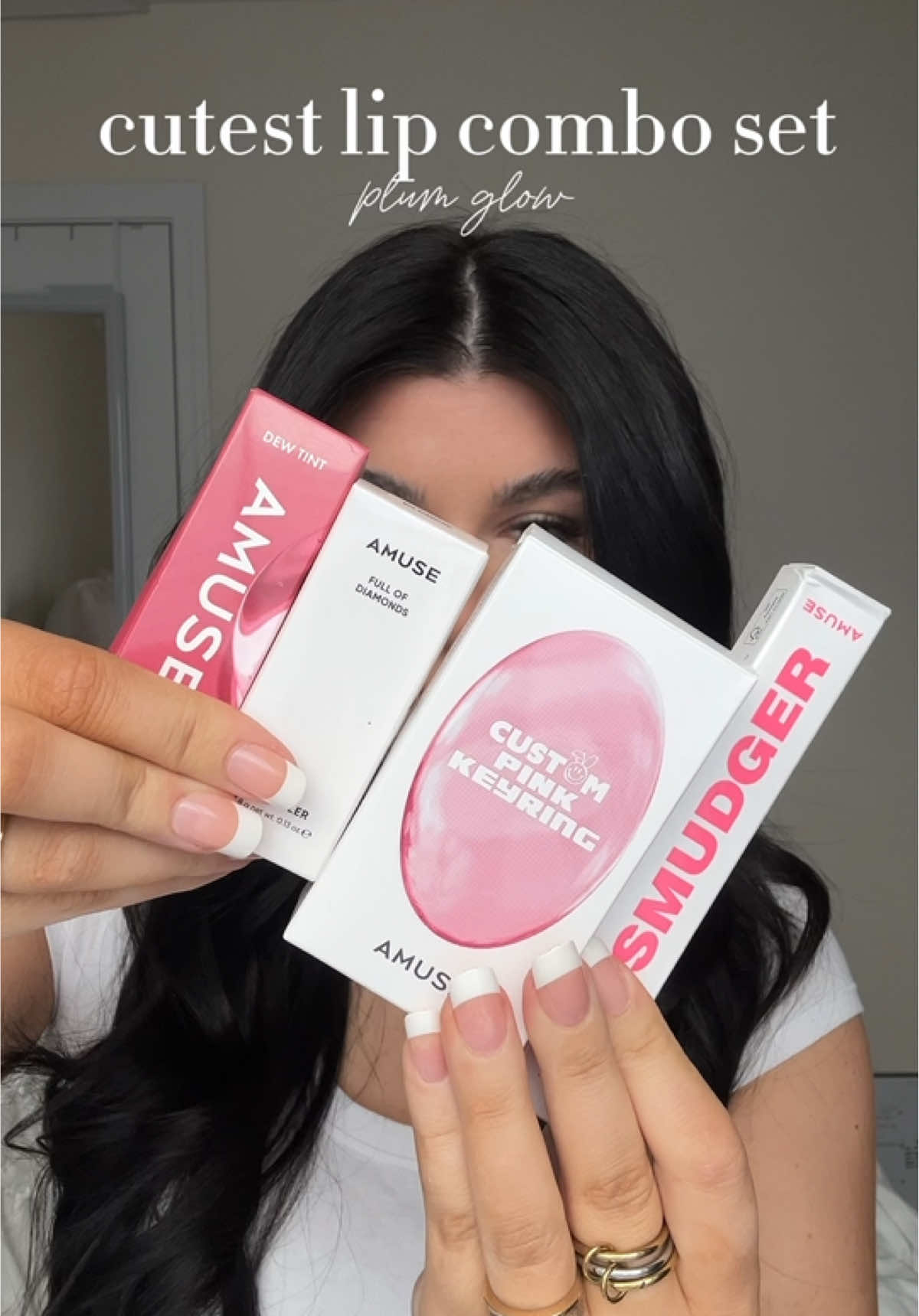 TikTok post by @itssabxoxo for AMUSE Seoul. Caption reads: the glossiest pinky lip combo✨ @AMUSE Seoul....