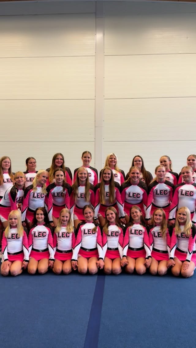Instagram post by @lahtielitecheerteam for Varsity Spirit. Caption reads: ✨ VARSITY REVEAL ✨ - OUR NEW UNIFORMS 🩷 We are so....
