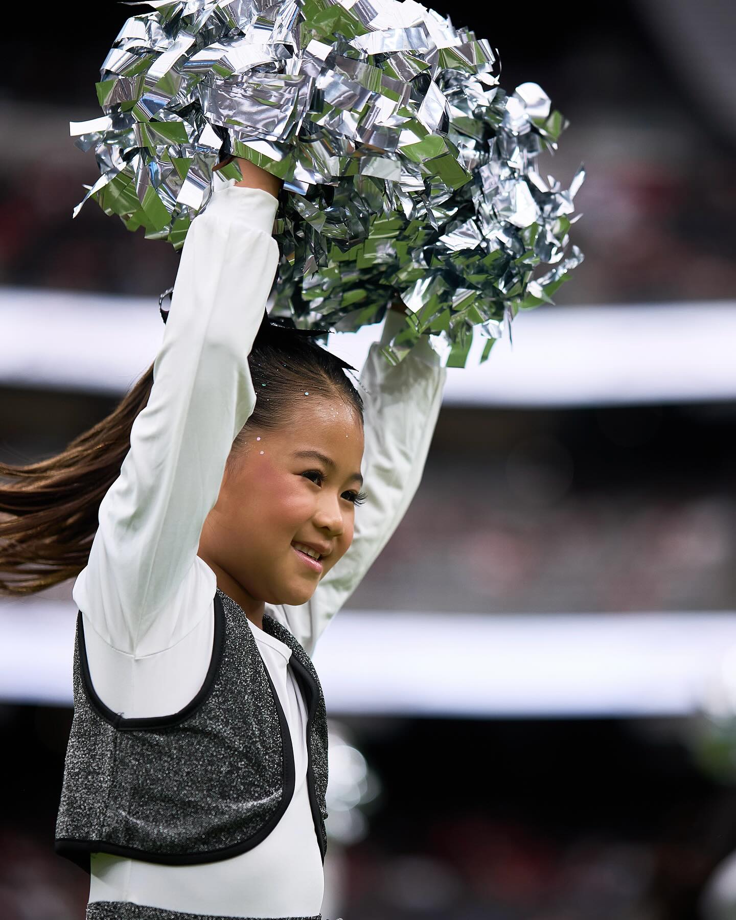 Instagram post by @raiderettes for Intermountain Health. Caption reads: Doesn’t get much cuter than this🥹 Head to....