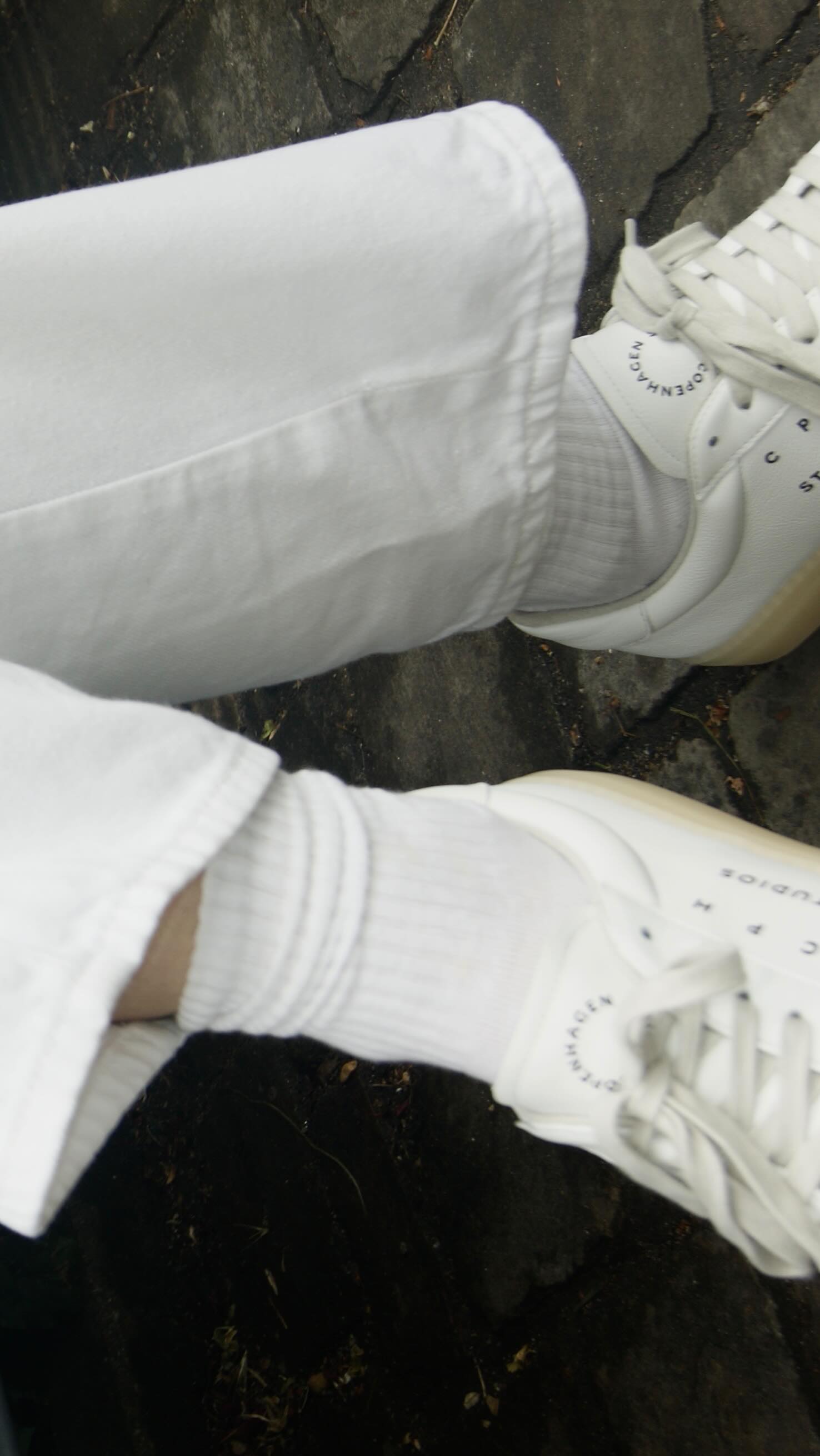 Instagram post by @janneaunan for COPENHAGEN STUDIOS. Caption reads: How I style my white sneakers for summer....