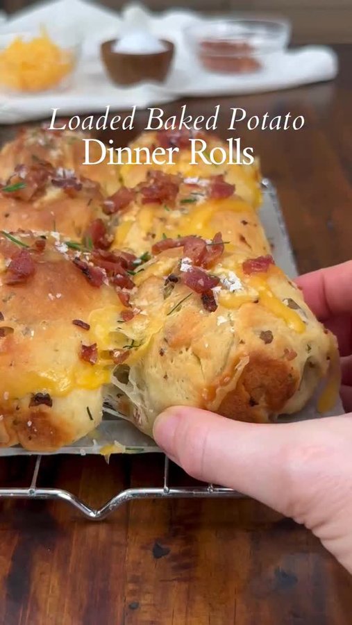 Instagram post by @thesaltycooker for King Arthur Baking Company. Caption reads: Loaded Baked Potato Dinner Rolls are soft, fluffy....