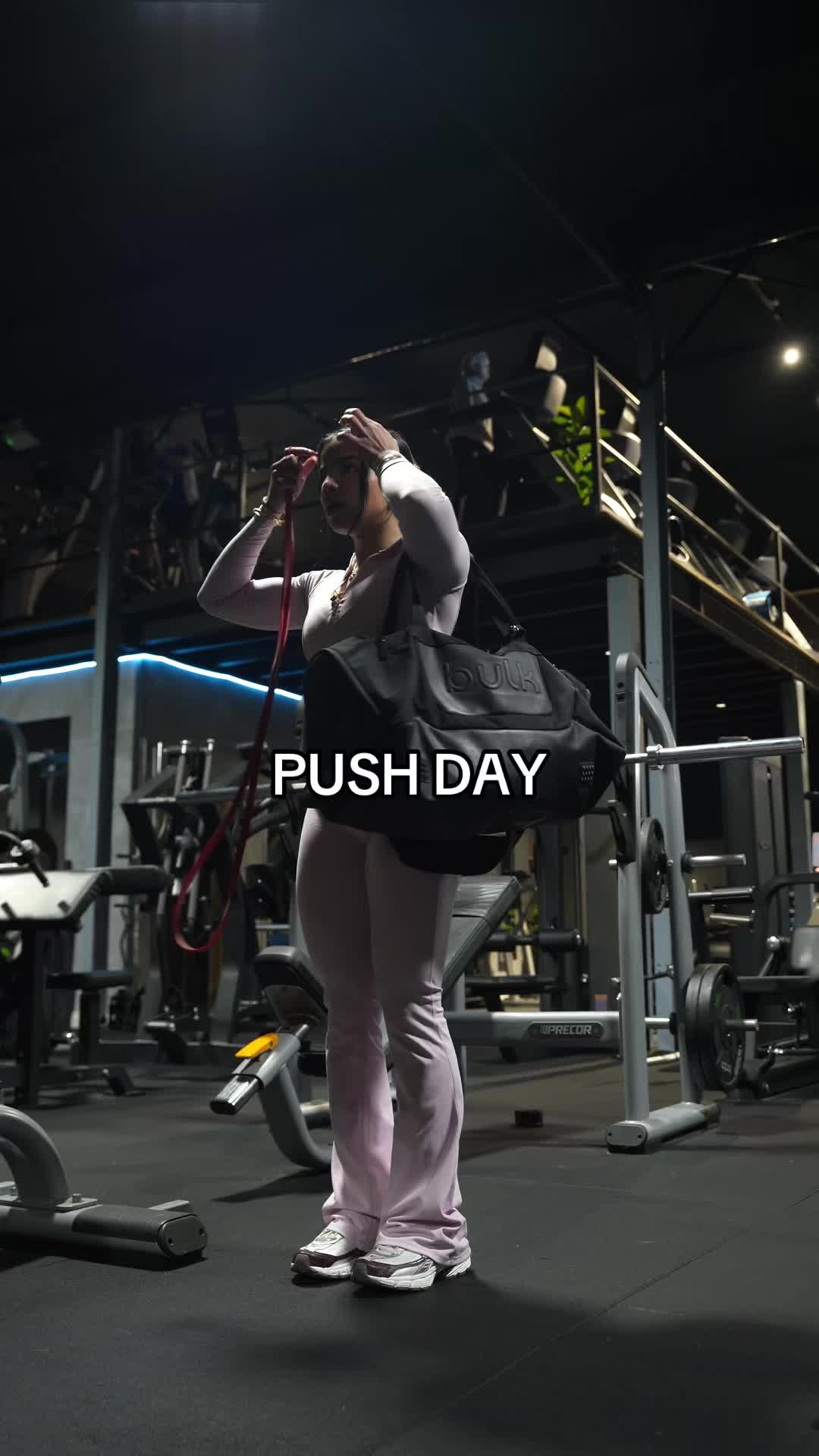 TikTok post by @raahavyy for YoungLA. Caption reads: pushing weight in pink🤝🏽 new @YoungLA for Her....