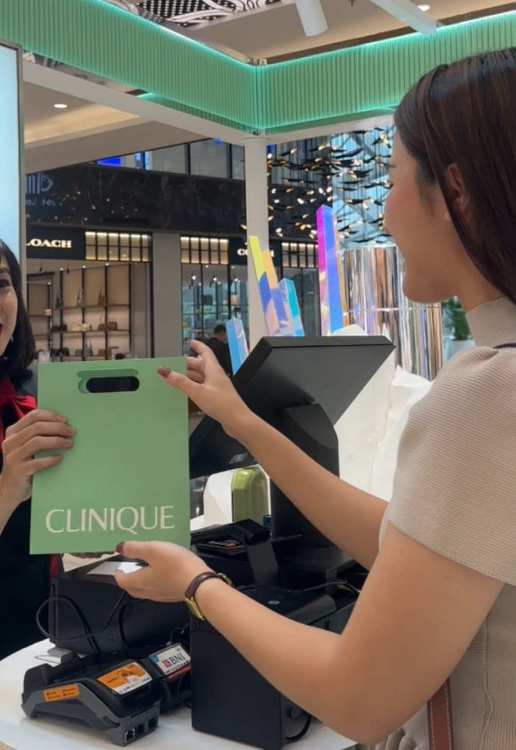 TikTok post by @mojarasyaa for Clinique. Caption reads: From skin analysis to Jewelry making activity only....