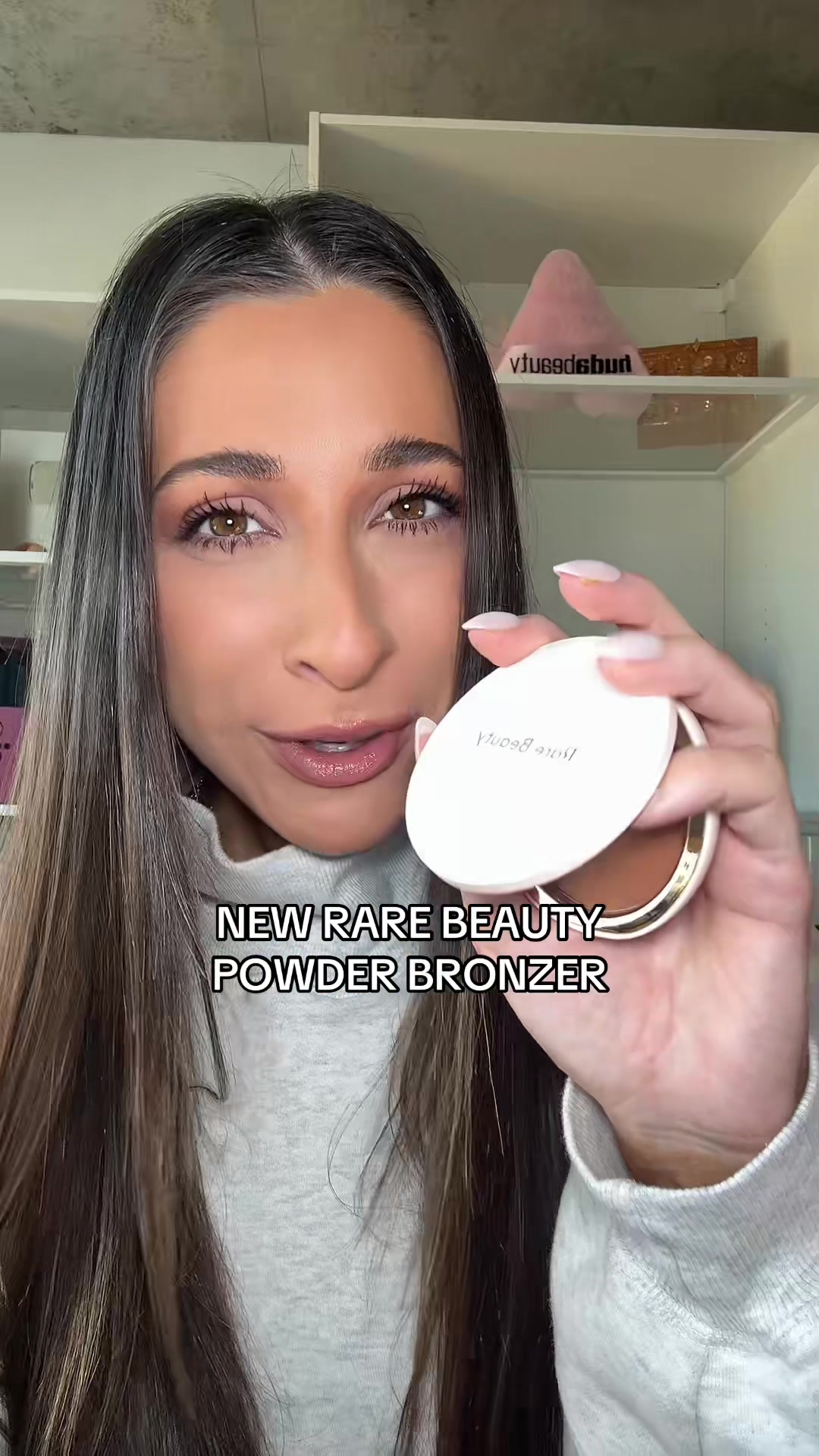 TikTok post by @allierosss for Rare Beauty. Caption reads: TRYING THE NEW @Rare Beauty POWDER BRONZER?!?....